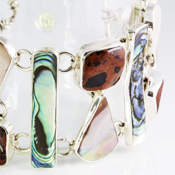 The sea and the volcano come together in this bracelet. .925 Sterling Silver, Obsidian, abalone and shell